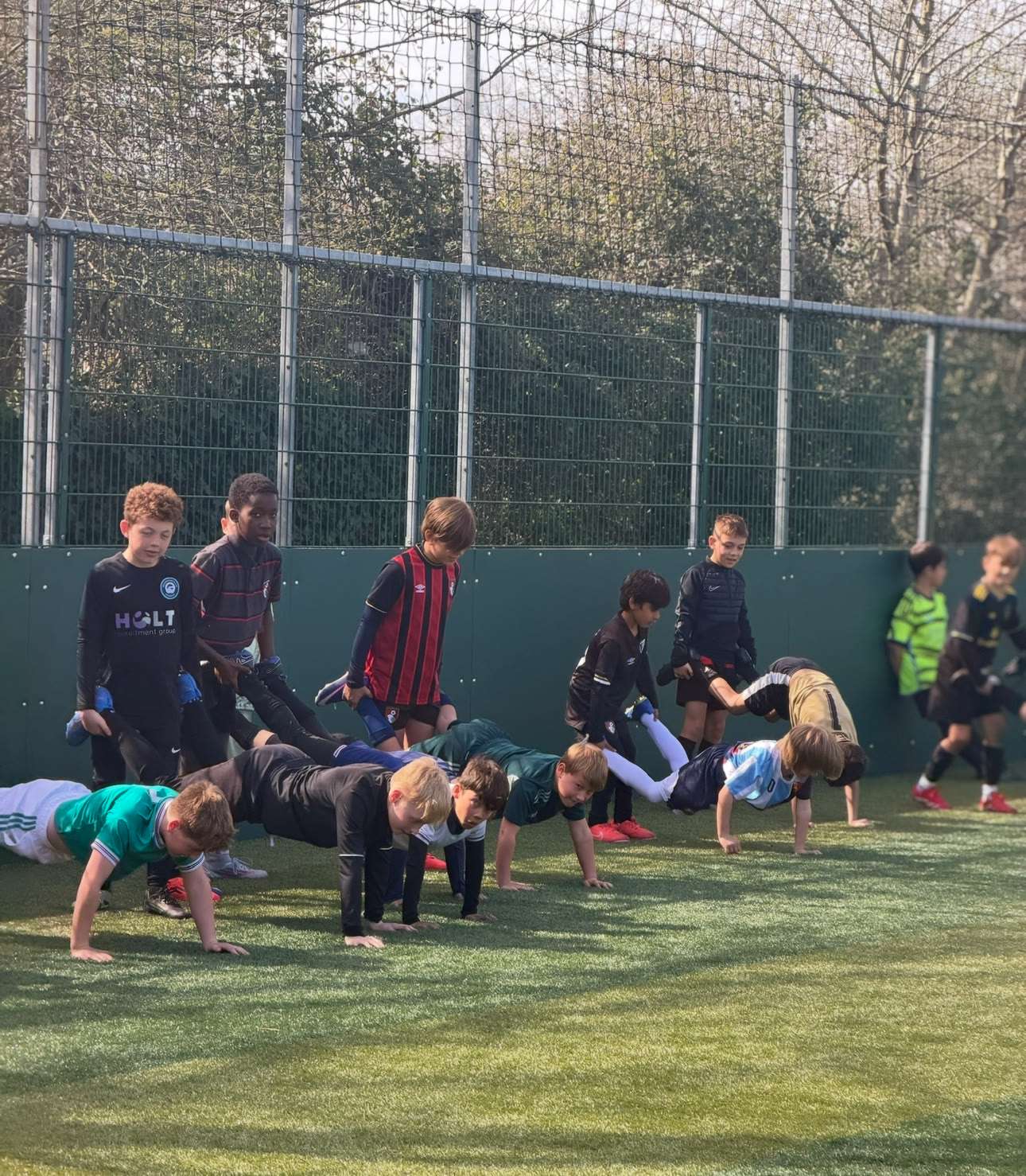 Children rotating through coached football activities