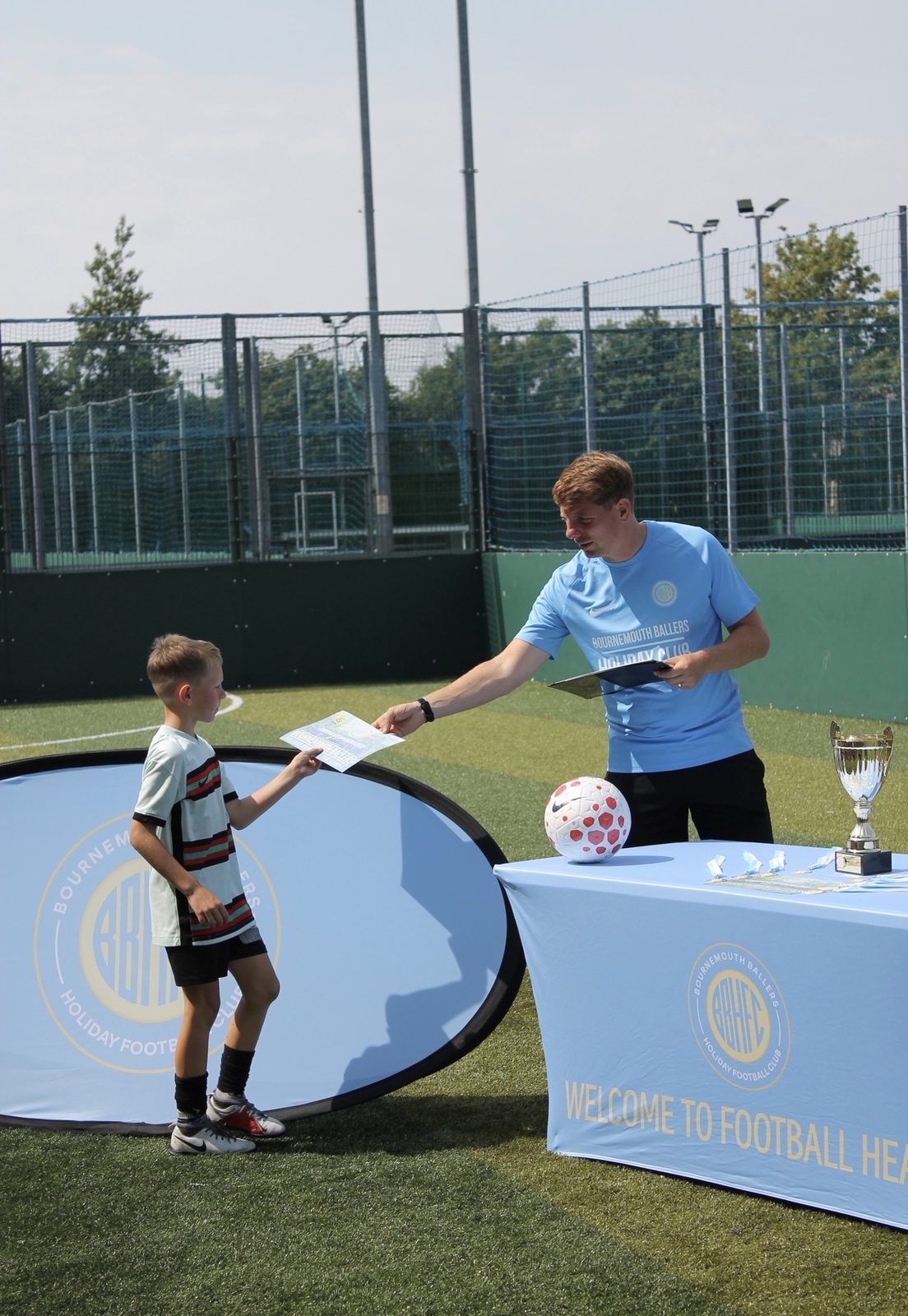 A young player collecting his Certificate of Excellence at the end-of-day presentation