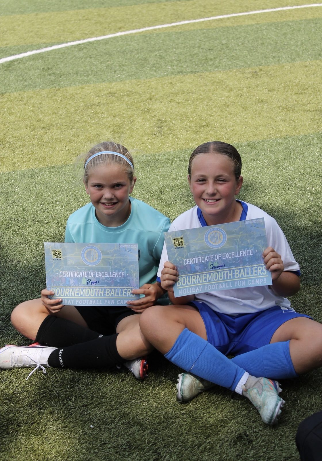 Two girls with their Certificates of Excellence at a Bournemouth Ballers summer camp