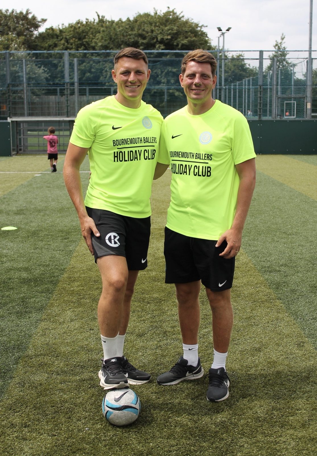 Two Bournemouth Ballers coaches on the pitch at Pelhams Park before a summer camp session
