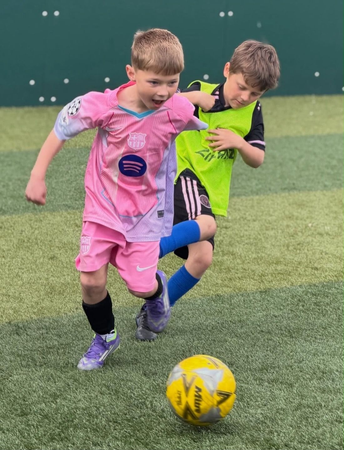 Children playing at a Bournemouth Ballers holiday football camp